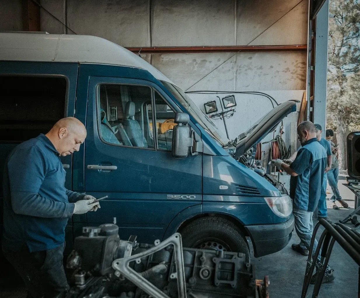 Fleet mechanic performing commercial vehicle repair in Houston TX shop bay — Road Runner Fleet Services