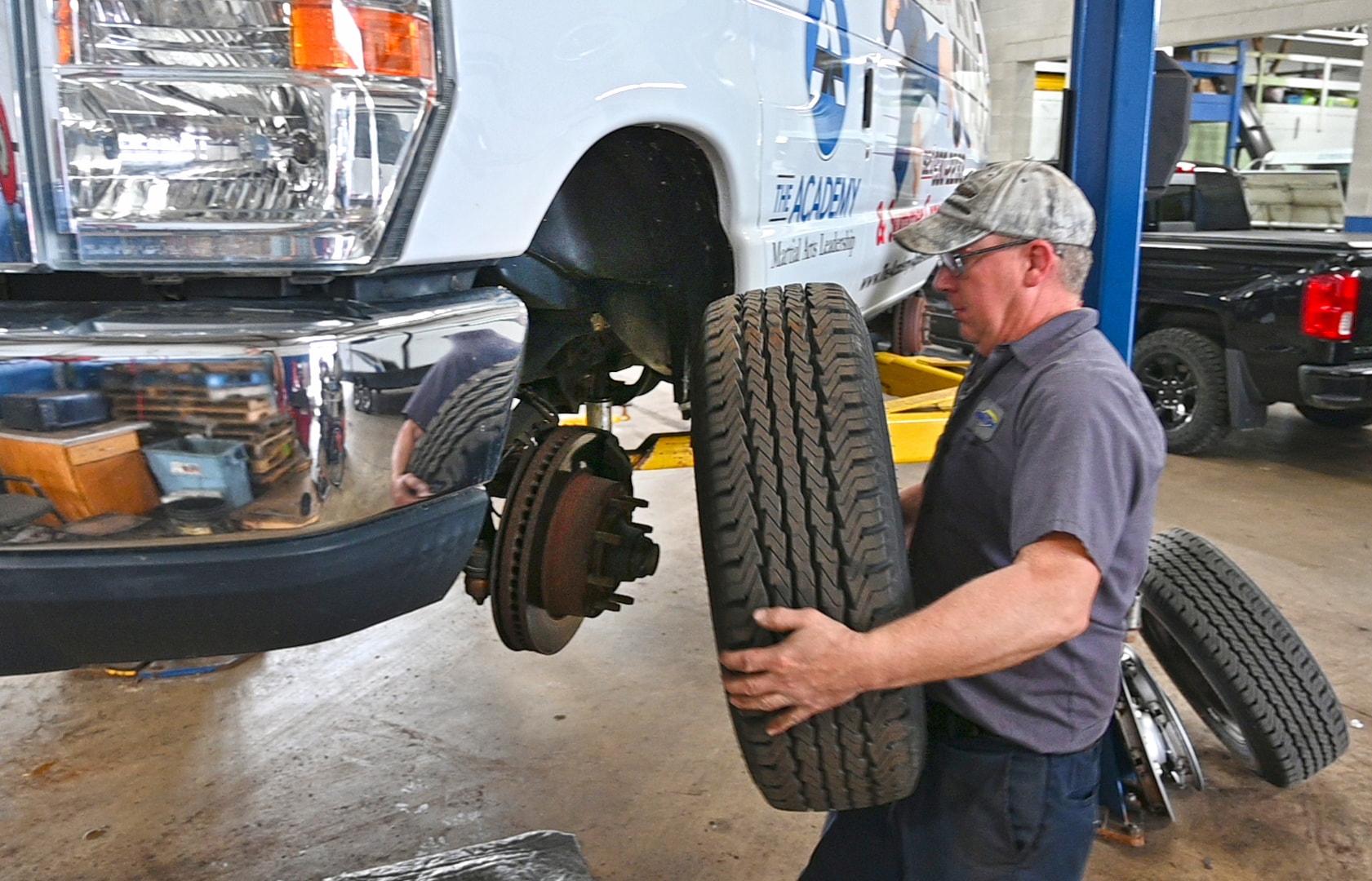 Tire service on commercial fleet van in Houston repair shop